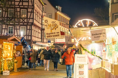 Night market with stalls selling stomach bread and cotton candy, Christmas market 2025, Nagold,