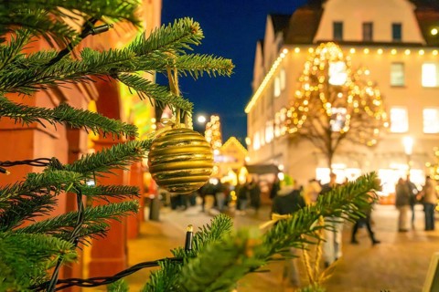 Christmas market lighting in an urban environment with tree balls in the foreground, Christmas