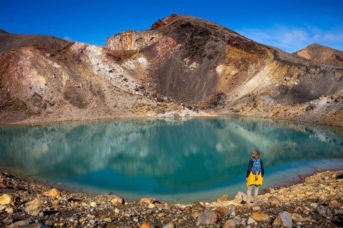 A hiker at one of the Emerald Lakes and Red Crater, Panorama, Tongariro alpine crossing, Tongariro