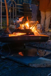 A burning fire provides warmth and comfort on a cool night, Aidlingen Christmas Market, Böblingen