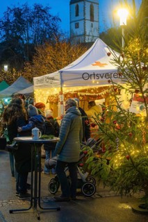A Christmas market with a tent and lights at night, Aidlingen Christmas market, Böblingen district,