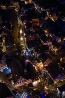 Village at night with tight street lights and festive lights, Aidlingen Christmas market, Böblingen