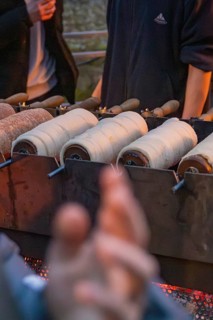 Fresh pastries are baked over an open fire at a market stand, Aidlingen Christmas Market, Böblingen
