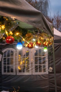 Festive Christmas decoration with lights and balls hanging on a tent, Aidlingen Christmas market,