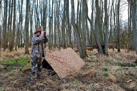 Camp of a nature photographer, nature photographer in front of his camouflage camp in the