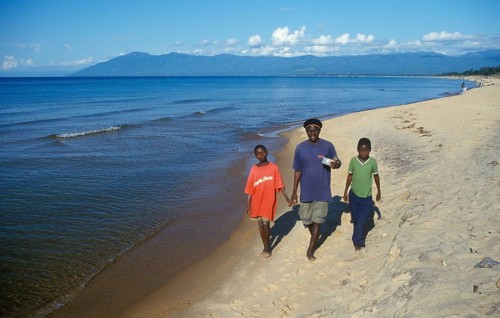 Two boys and a young man stroll along Kande Beach on Lake Malawi, Malawi, Africa, July 2000,