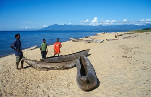 Local man and boy with canoes near Kande Beach on Lake Malawi, Malawi, Africa, July 2000, vintage,