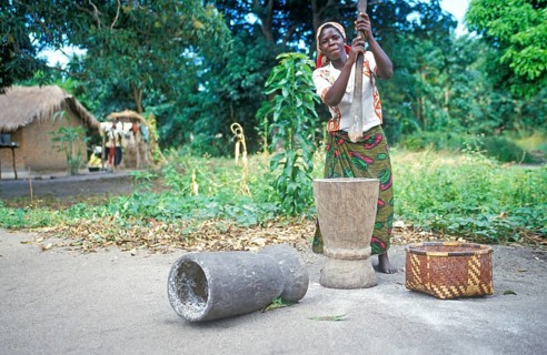 Woman stomping cassava in a village near Kande on Lake Malawi, Malawi, Africa, July 2000, vintage,