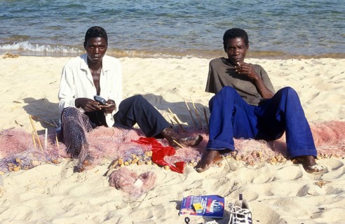 Fishermen at Kande Beach on Lake Malawi repair their nets, Malawi, Africa, July 2000, vintage,