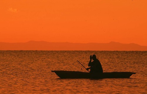 Sunrise over Lake Malawi, man in dugout, Kande, Malawi, Africa, July 2000, vintage, retro, old,