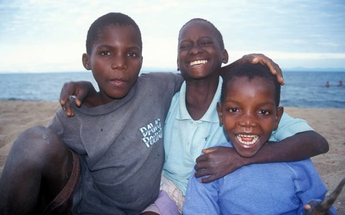 Three boys posing for camera, Chitimba, Lake Malawi, Africa, July 2000, vintage, retro, old,