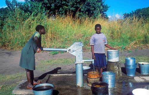 Two young woman at a well in a village near Kande on Lake Malawi, Malawi, Africa, July 2000,
