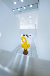 Large, modern yellow sculpture in a contemporary exhibition space, Open Horizons exhibition,
