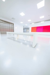 Empty, bright room with white bench and colored painting on the wall, Open Horizons exhibition,