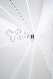 A bright, narrow corridor with artistic wall decorations in modern style, Open Horizons exhibition,
