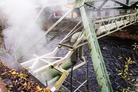 District heating pipeline over the Wupper river, steam escapes, Wuppertal, Germany
