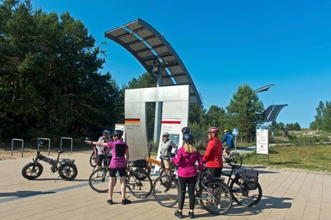 Cyclists at the symbolic gate on the border between Germany and Poland on the Europa Promenade,