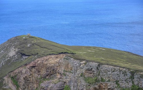 Eire sign from World War II, Portacloy loop cliff walk, Muingnabo, County Mayo, Ireland