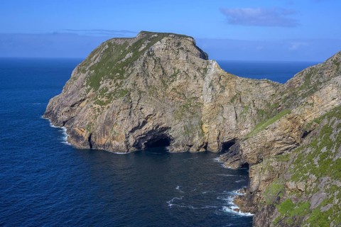 View of blue sea and cliffs with rock gate from Portacloy Loop Cliff Walk, Muingnabo, County Mayo,