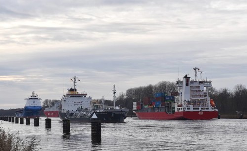Ships, container ships, cargo ships, tankers meet in front of sunset in the Kiel Canal, NOK, Kiel