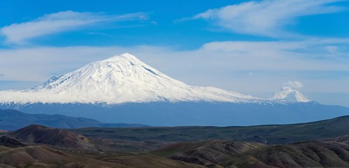 Panorama of snow-covered mountain and sky framed by vast landscape, large and small Ararat, BÃ¼yÃ¼k