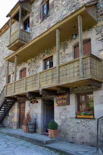 Rustic stone house with wooden balconies and flower box in traditional design, Old Town,