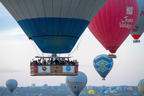 Close-up of a hot air balloon basket with people looking forward to an adventurous ride in clear