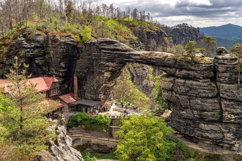 The Prebischtor rock arch and the Hotel Falkennest or SokolÃ­ hnÃ­zdo in the Bohemian Switzerland