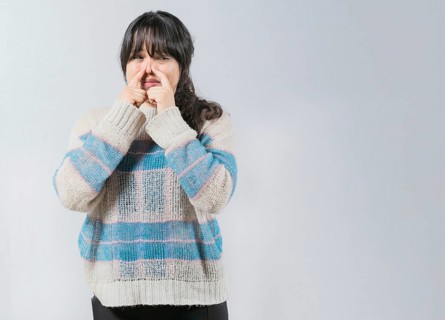 Asian woman covering nose because bad smells. Asian girl with a face from unpleasant odors. Concept