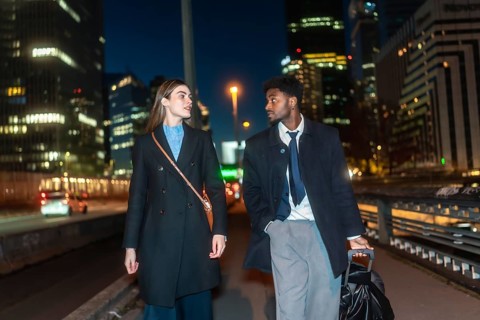 Professional associates discussing work while strolling through a modern urban environment