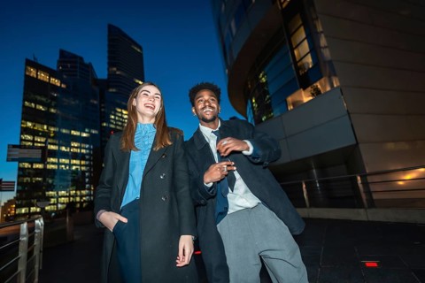 Diverse businesspeople enjoying a joyful moment together while standing on a promenade with