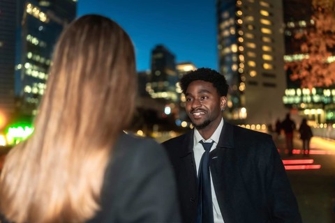 Young african american man engaging in a business conversation with a female colleague outdoors,