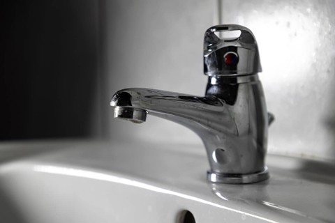 Modern chrome plated faucet in a bathroom