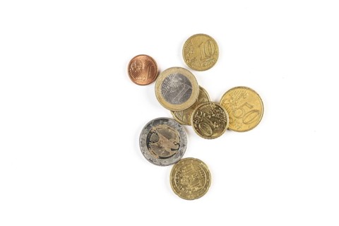 Different euro coins of different denominations on a white background