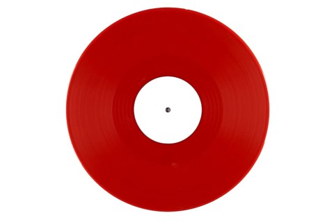 Red vinyl record with a white label in the middle on a white background