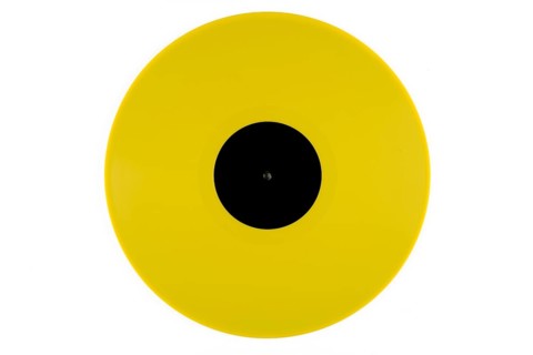 Light yellow phonograph record with a black label in the middle on a white background