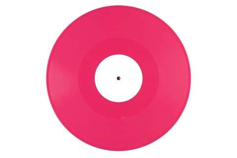 Pink vinyl record with a white label in the middle on a white background