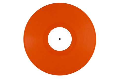 Orange vinyl record with a white label in the middle on a white background