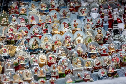 Christmas market, sales stand for decorative items, snow globes with Christmas motifs, North