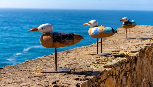 Wooden seagulls, art on the fortress at Farol de Nazare lighthouse, an annual meeting place in