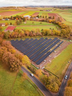 Solar systems in the middle of an autumnal landscape with a rural road, construction PV