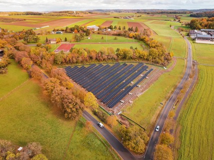 Panoramic view of solar panels surrounded by landscape characterized by autumn leaves, PV