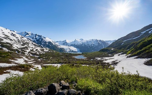 View from Portage Pass of Divide Lake, snowy mountain peaks and glaciers Portage Glacier, Portage