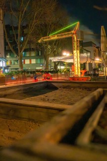 Evening street scene with illuminated construction crane and surrounding buildings, Sindelfingen,