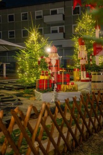 Christmas decorations with gifts and fir trees, illuminated with festive lights, Sindelfingen,