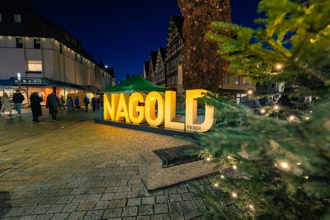 Festive scene at night with illuminated Nagold lettering and people, Christmas market 2025, Nagold,