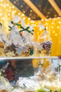 Christmas cookies in transparent packaging, illuminated by festive light at a market, Christmas