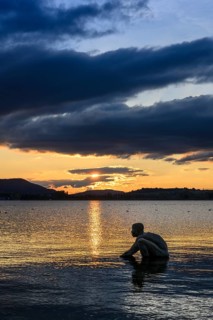 Bronze sculpture El NiÃ±o on the lakeside of Radolfzell am Lake Constance at sunset, Konstanz