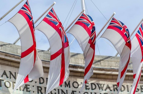 The Admiralty Arch decorated with the flags of the Royal Navy's White Ensign, London England, Great