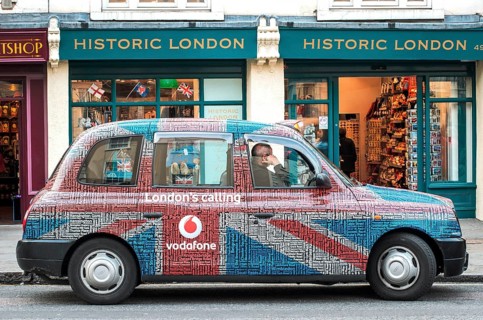 A London taxi with a special taxi advertisement from the London's calling advertising campaign by